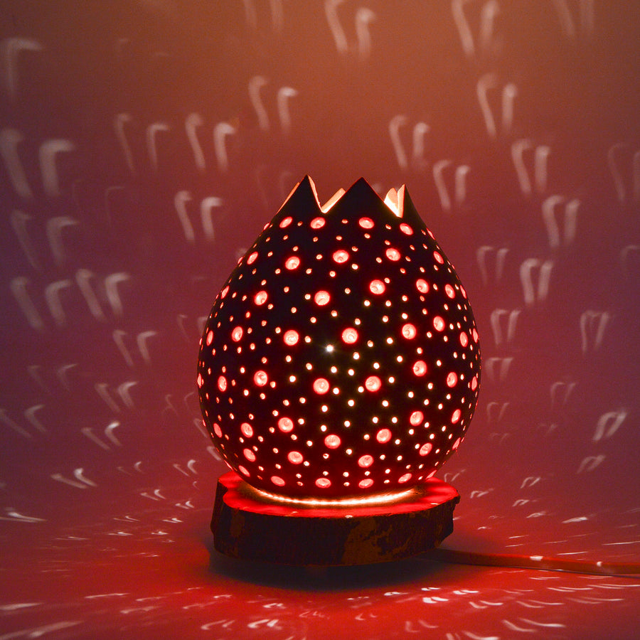 Small table lamp made of carved beaded pumpkin.